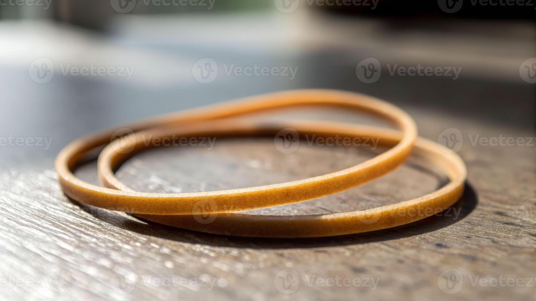 Action of stretching rubber bands indoor workspace close-up material shot natural light focused viewpoint photo