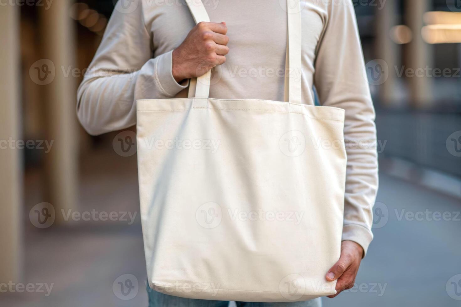 Soft close-up view of a person holding a soft tote bag urban environment lifestyle concept photo
