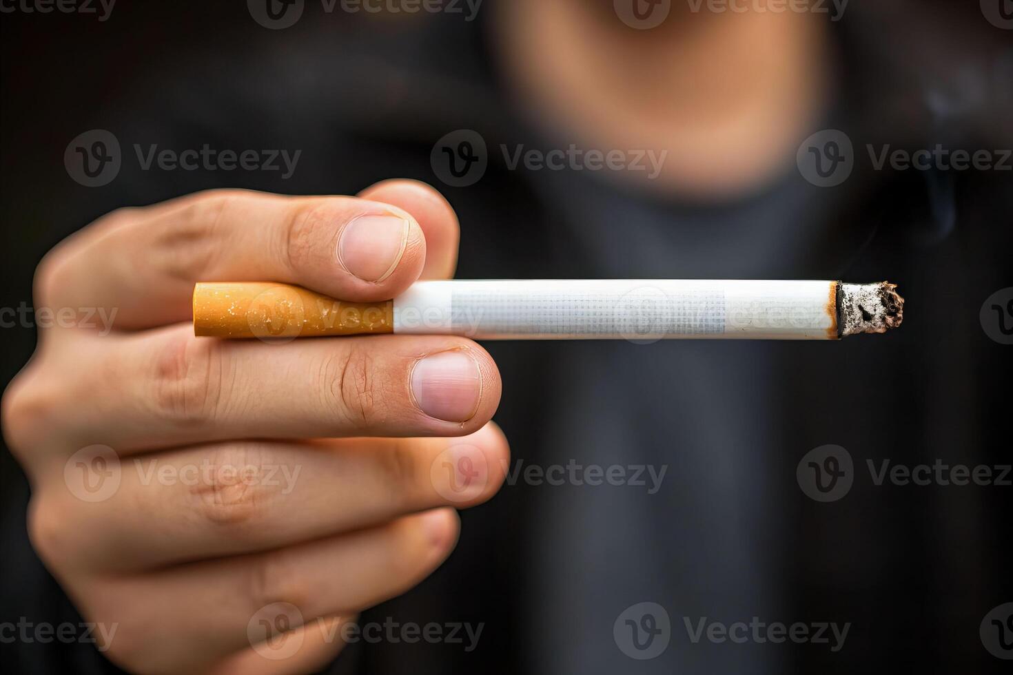 Dangers of smoking a close-up view of a person's hand holding a cigarette urban environment highlighting death risks photo