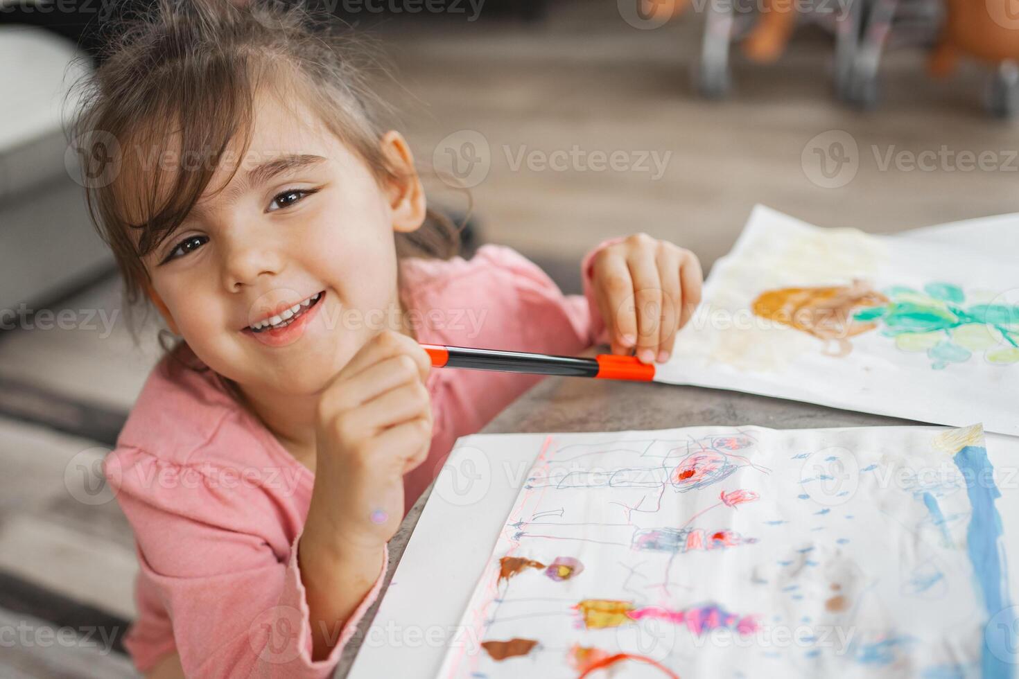 Joyful child engaged in colorful art project at home photo