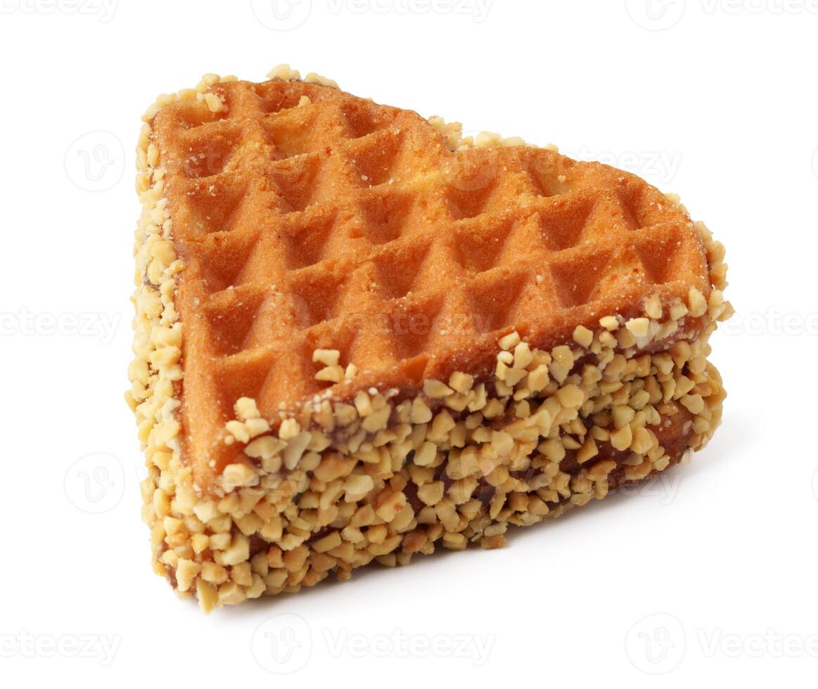 Triangular waffle coated with nuts resting on a white background, perfect for dessert lovers photo