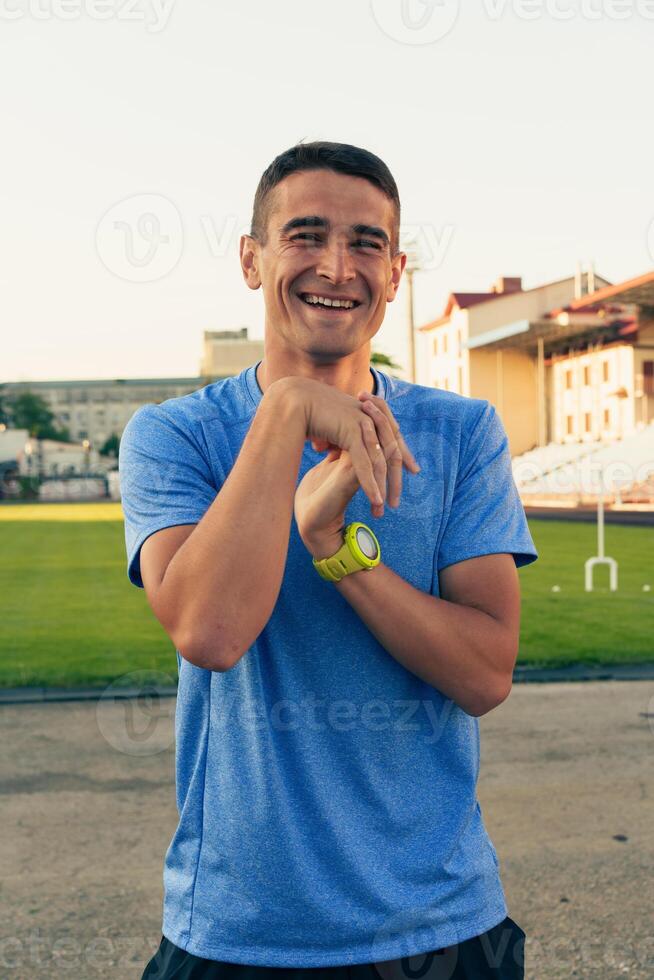 Smiling athlete enjoying sunlight at a sports field during training session in summer photo