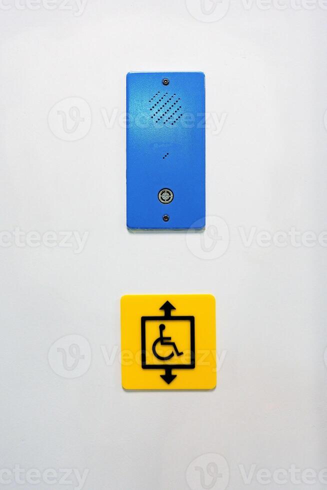 Sign indicating accessibility features for mobility-impaired individuals in a public building photo