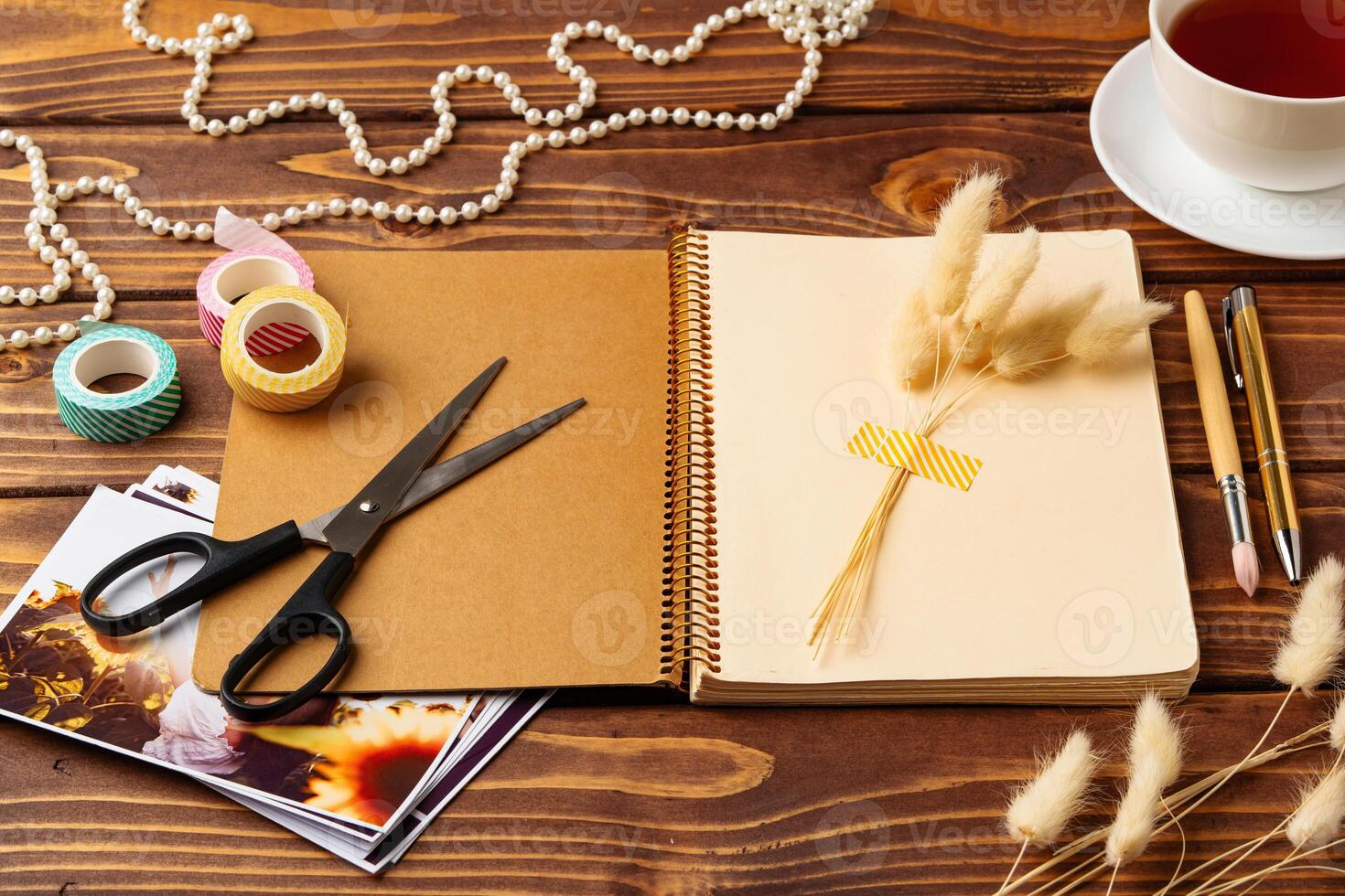 Creative workspace with scrapbook materials and decorative elements during the day photo