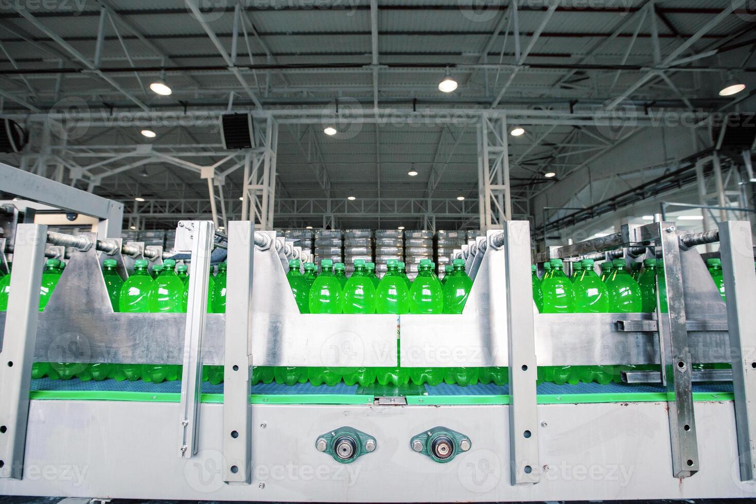 Bottling process of green soda drinks in a modern factory setting with multiple production lines operating photo