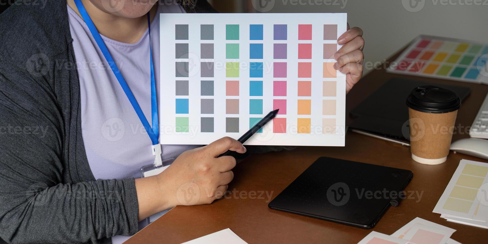 Graphic designer showcasing a vibrant color palette for creative projects photo