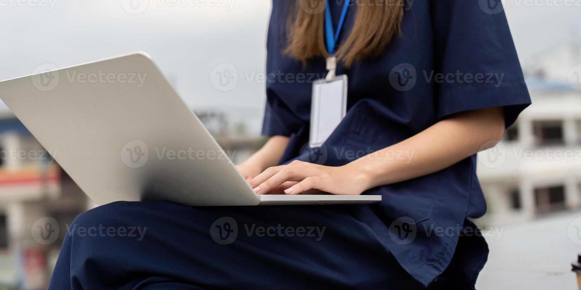 Nurse working on a laptop for patient documentation during a break photo