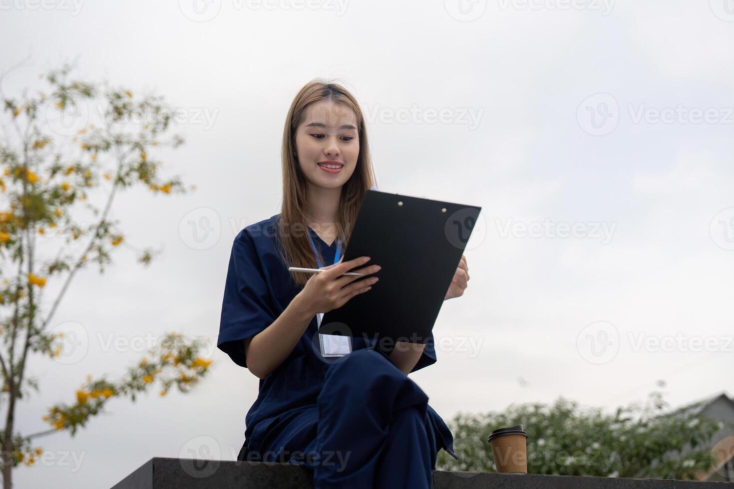Nurse reviewing patient notes on a clipboard during a break photo