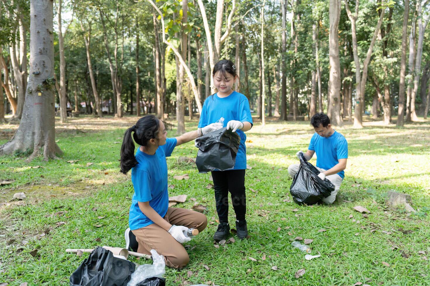 Engaged family volunteering for garbage collection in a park, fostering environmental stewardship and community involvement. photo