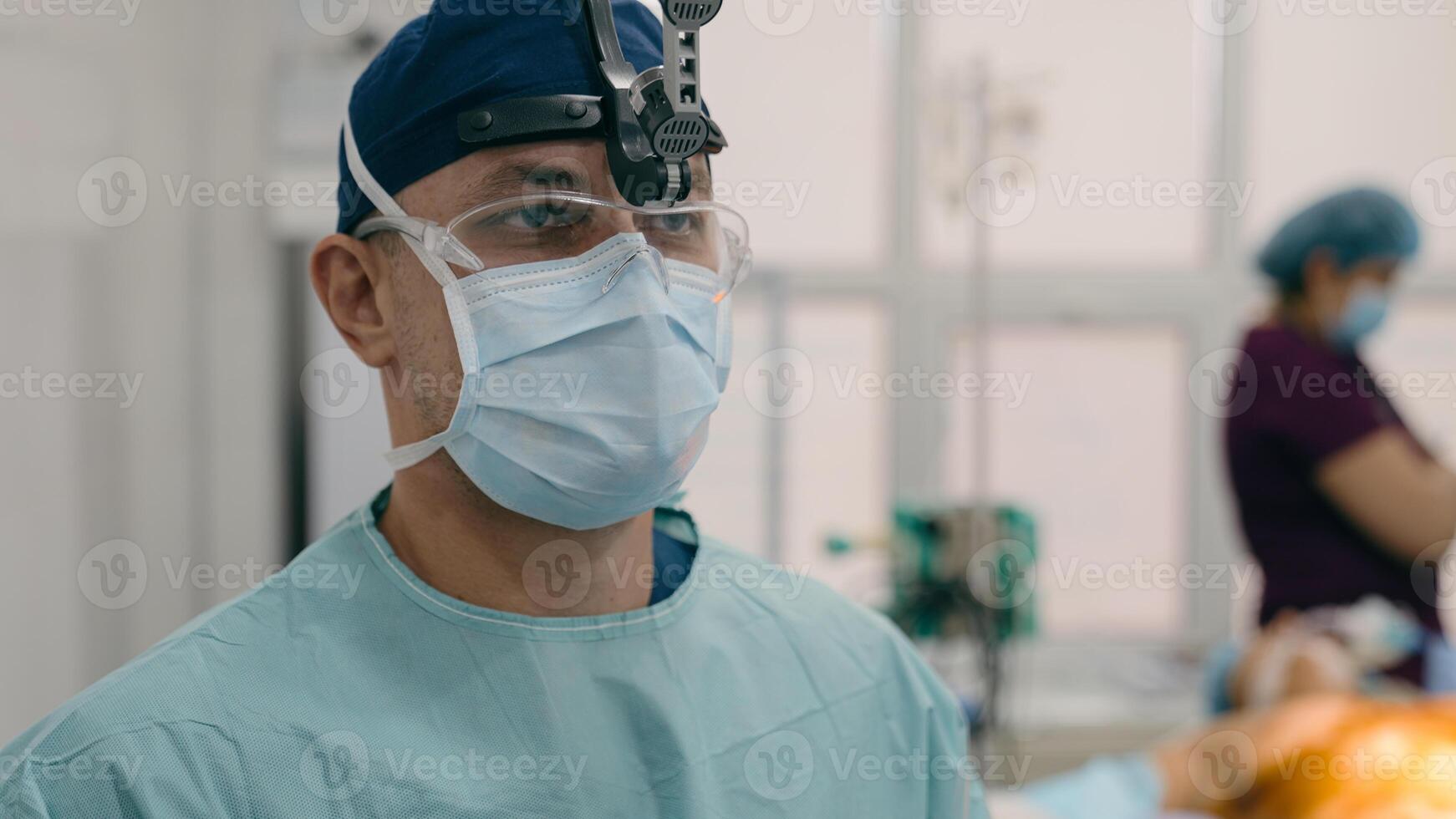 Close up man doctor professional surgeon physician in medical uniform binocular. Team of medics prepare for operation in surgery room on background copy space hospital medical and health care services photo