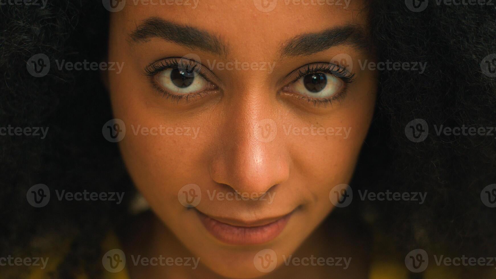 Close up face African American ethnic business woman businesswoman student eyesight stare dark eyes female teenager girl gaze looking at camera skincare health medical consultation headshot portrait photo