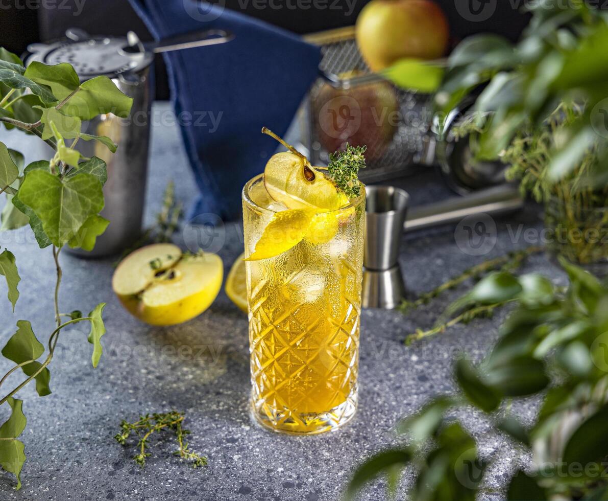 Refreshing apple cider cocktail with thyme and lemon garnish photo