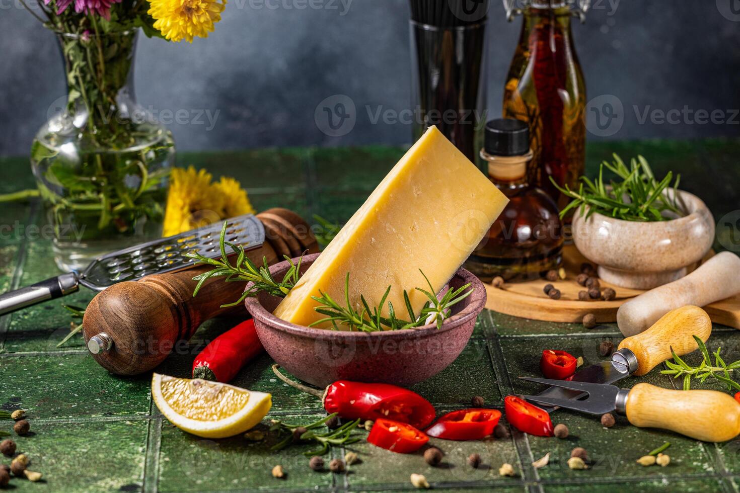 Block of hard cheese with rosemary sprigs and assorted spices for cooking photo