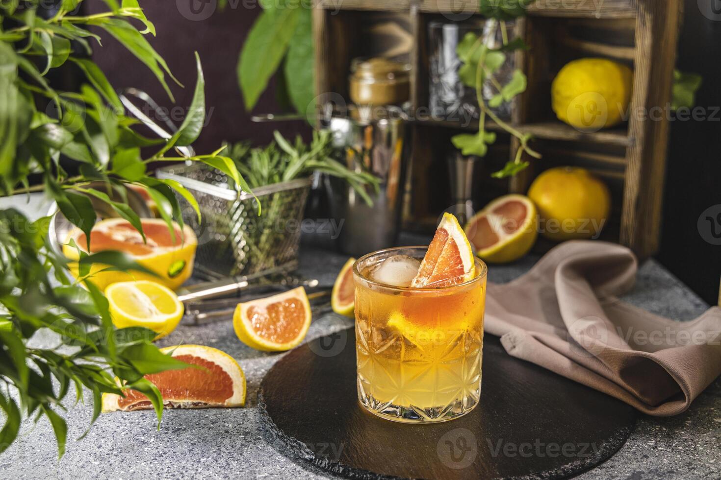 Refreshing paloma cocktail with grapefruit and ice on table photo