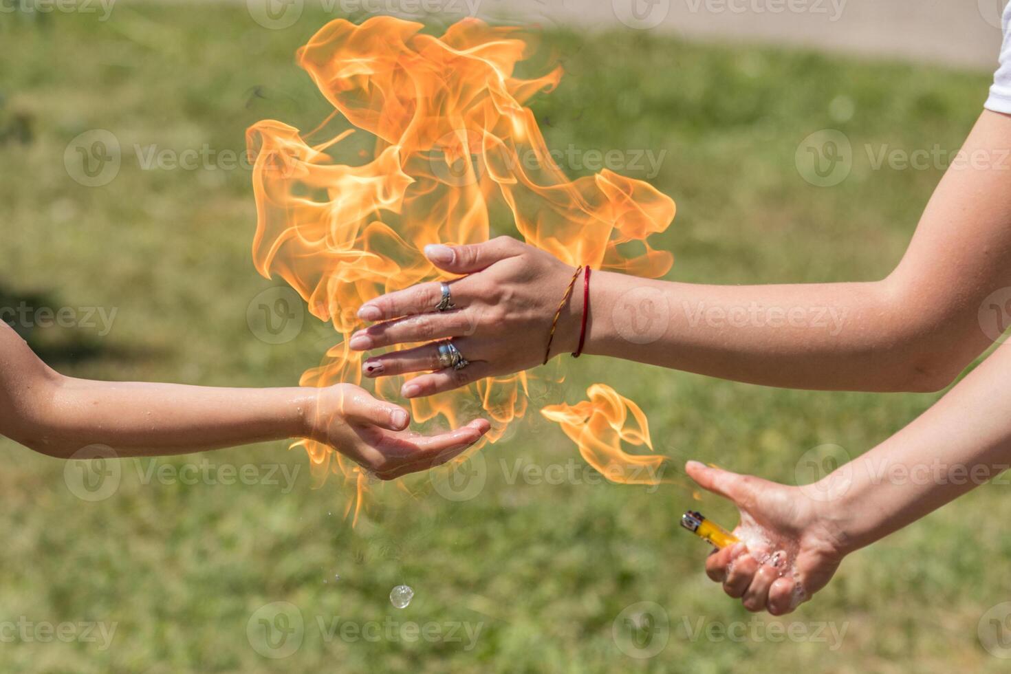 Street performer holding fire in hand outdoors photo