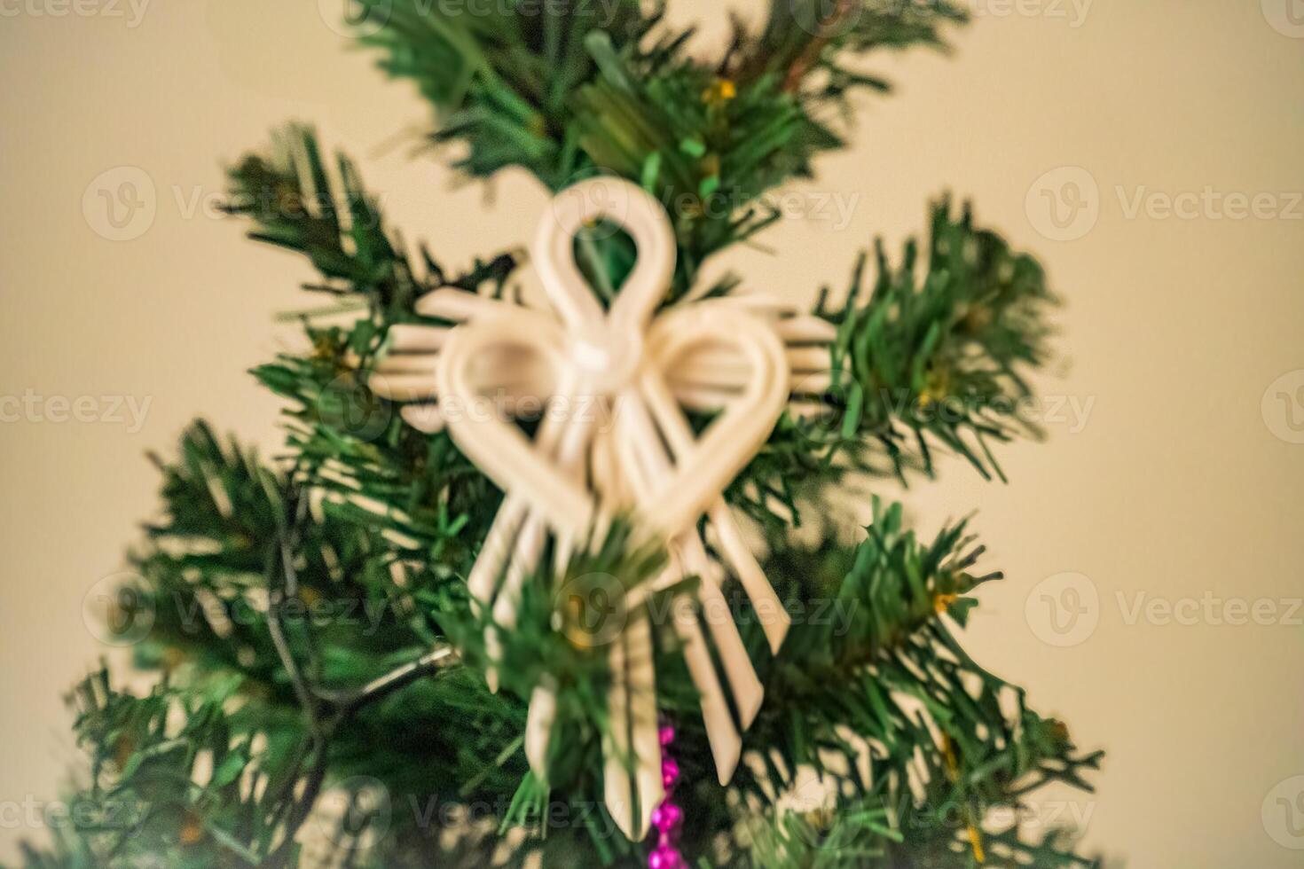 Christmas angel straw ornament on blurred background with copy space. photo