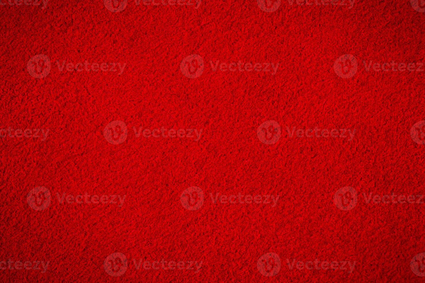 Red suede with darkening along the edge. Suede macro as a background. photo