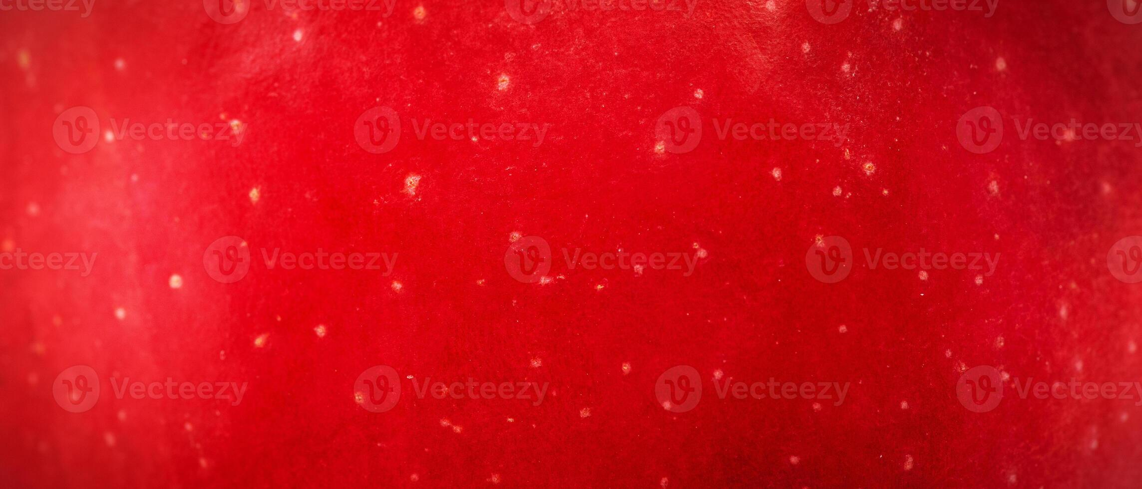Texture of red apple skin macro photo banner size background.