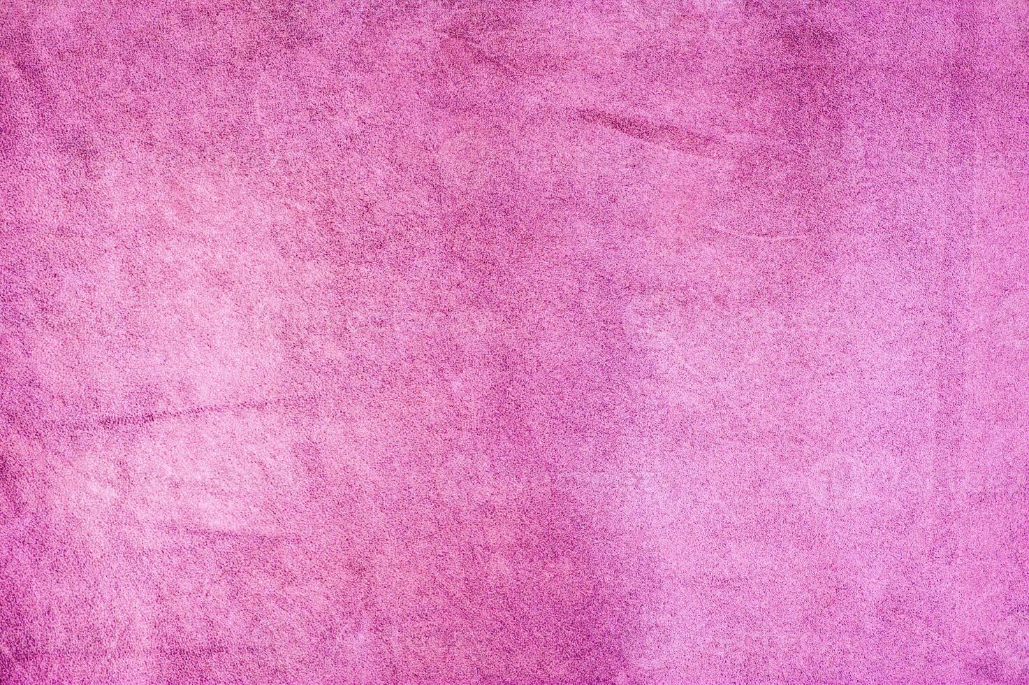 Raspberry pink suede background. Light pink purple suede leather macro photo. photo