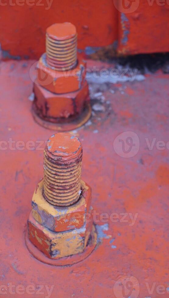 a close up of two orange bolts photo
