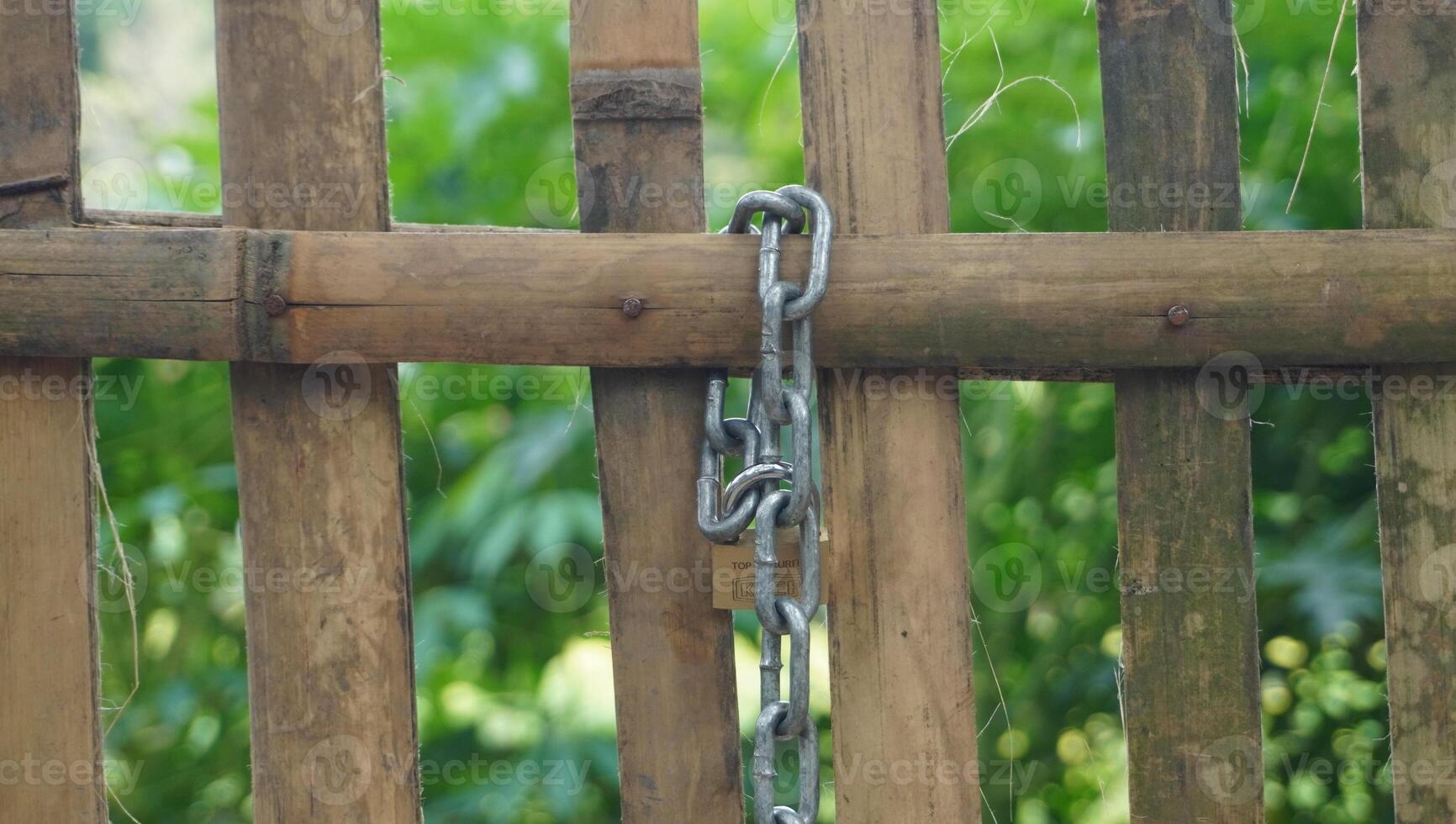 a wooden fence with a chain attached to it photo