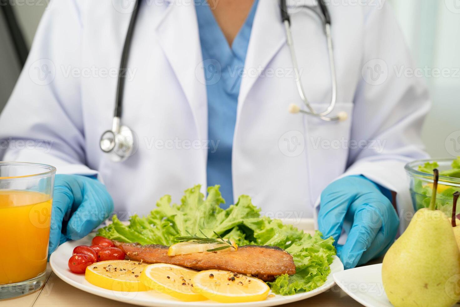 Asian Nutritionist holding healthy food for patient in hospital, nutrition photo