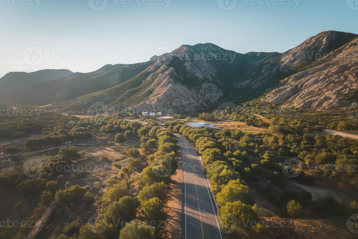 Sunny road through a green valley photo