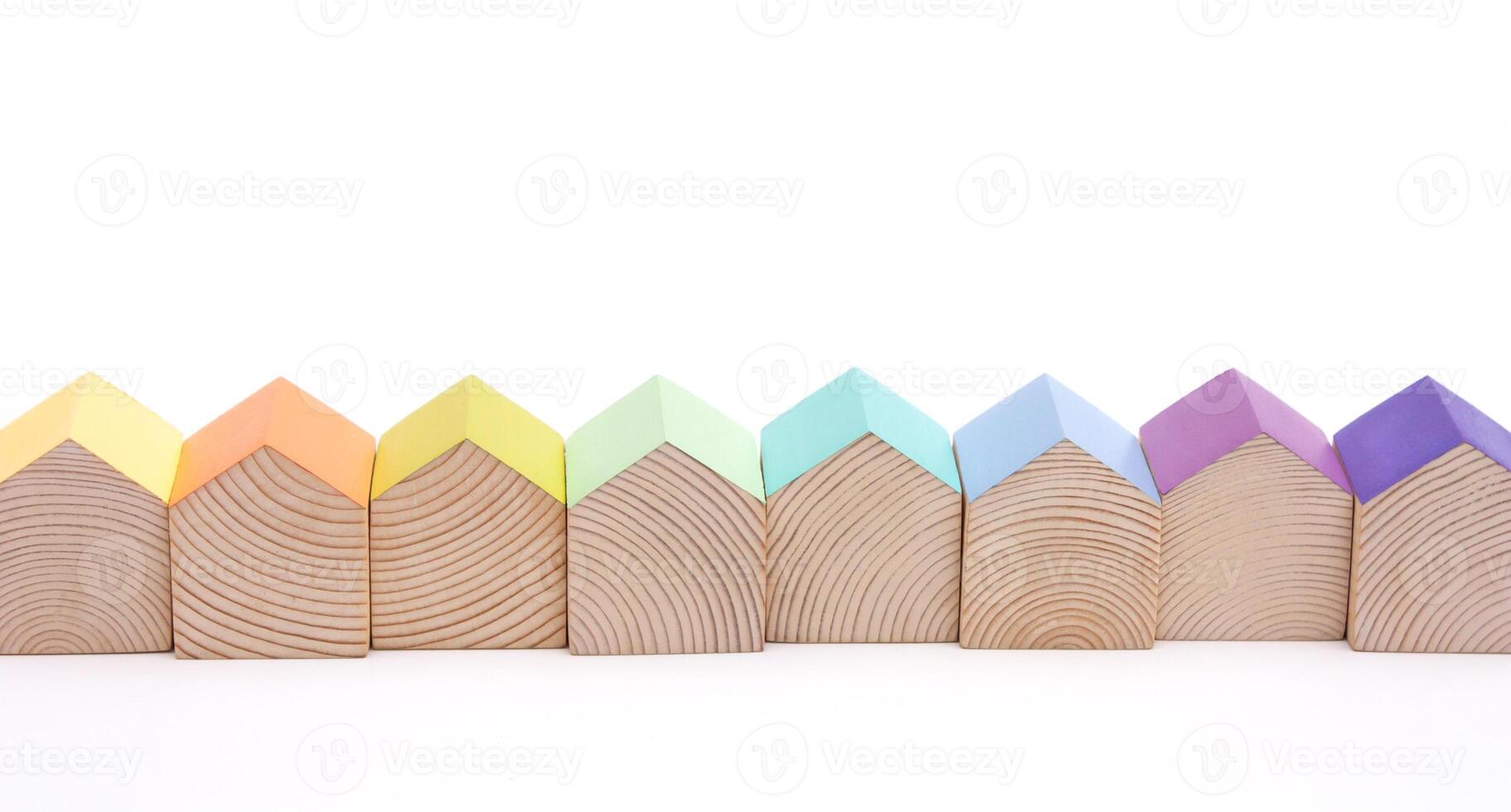 Wooden houses with colorful roofs arranged in row on white background. photo