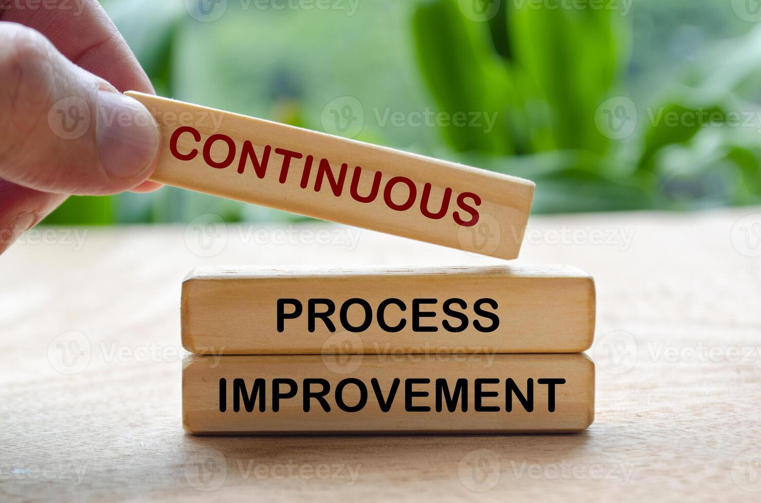 Continuous process improvement text on wooden blocks. Business strategy and improvement concept photo