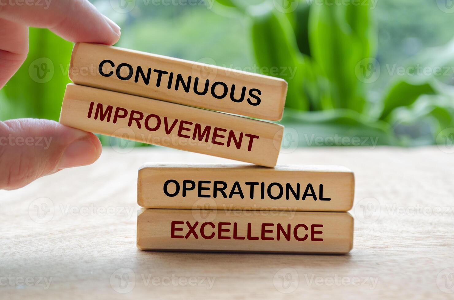 Continuous improvement and operational excellence text on wooden blocks. Business strategy and improvement concept photo