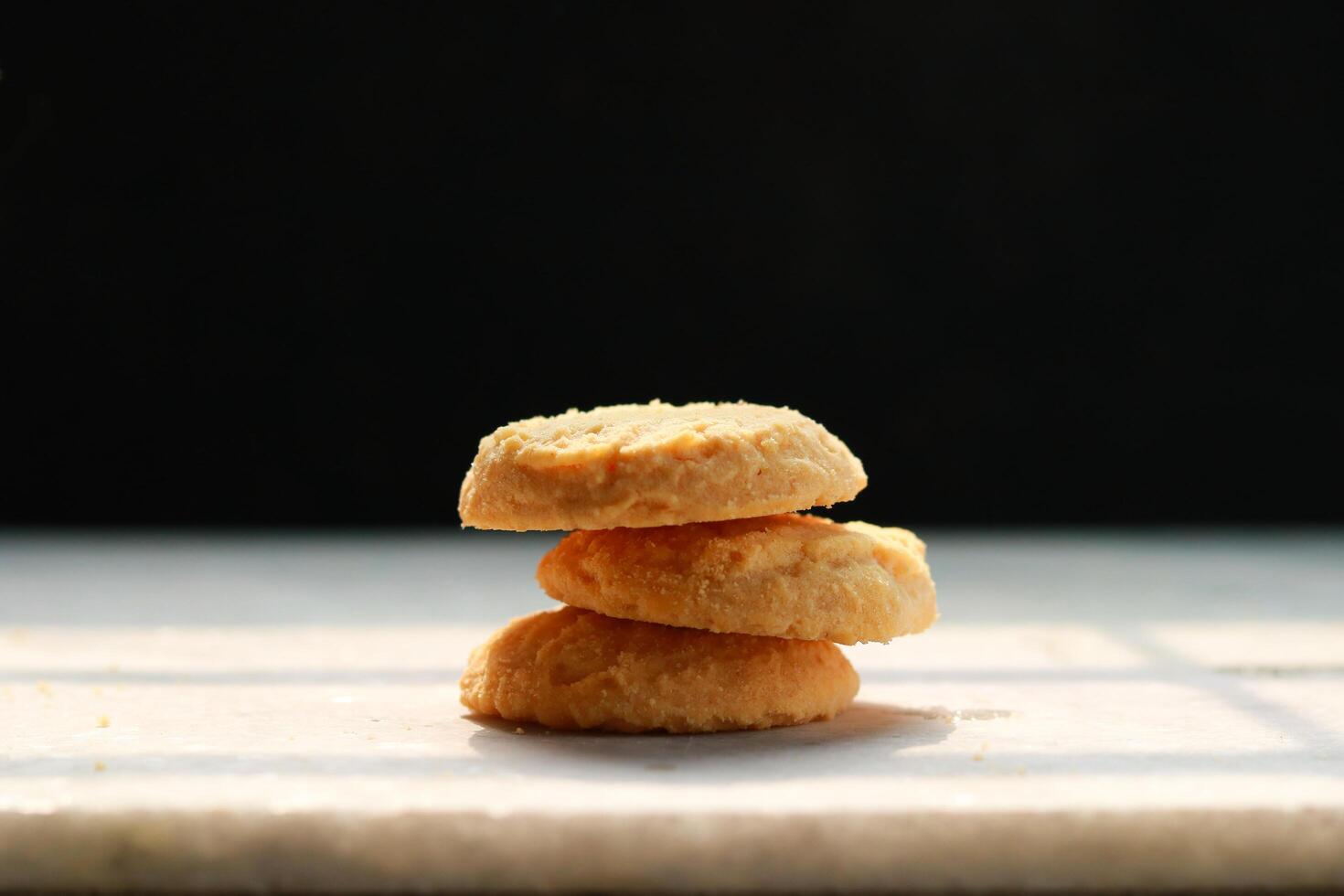 Cookies on a white table with a black background, shallow depth of field photo