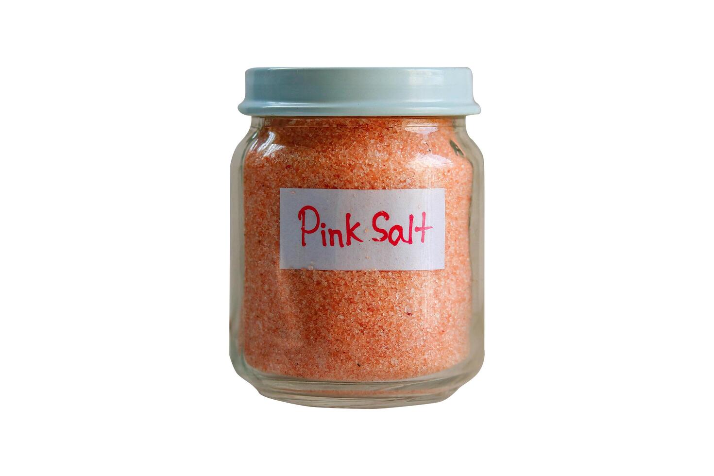 Glass jar of pink salt isolated on a white background. Clipping path photo