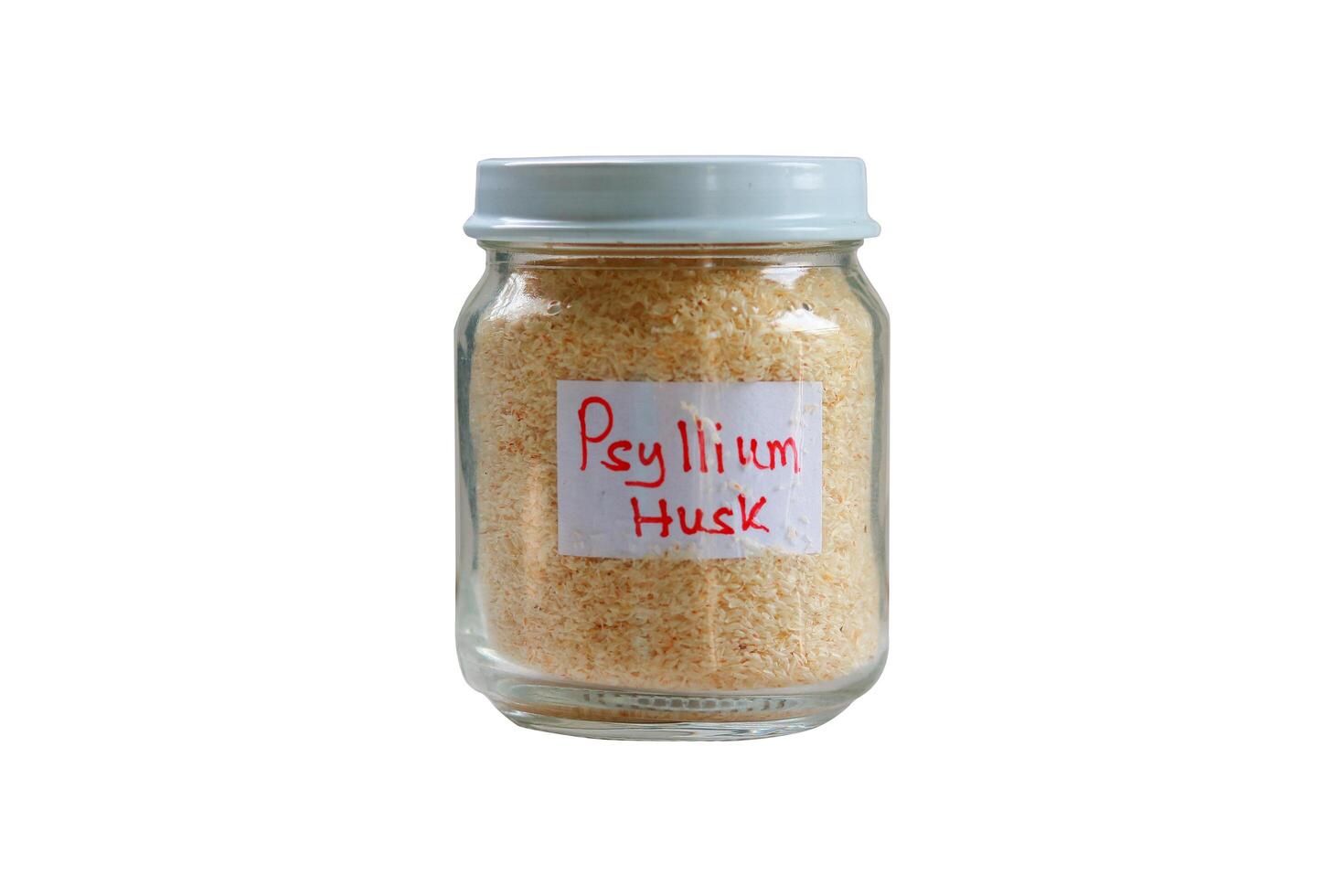 Psyllium husk in a Glass jar with food label, isolated on a white background. photo