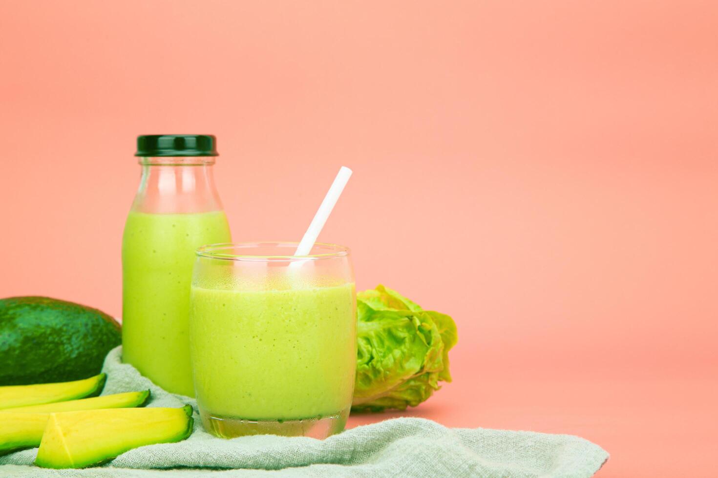 Avocado and green cos salad blended in a glass and bottle, healthy drinking water. horizontal photo