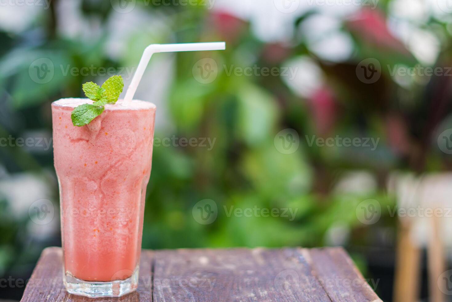 Cool, refreshing watermelon smoothie in a transparent glass. Leave space for letters. photo