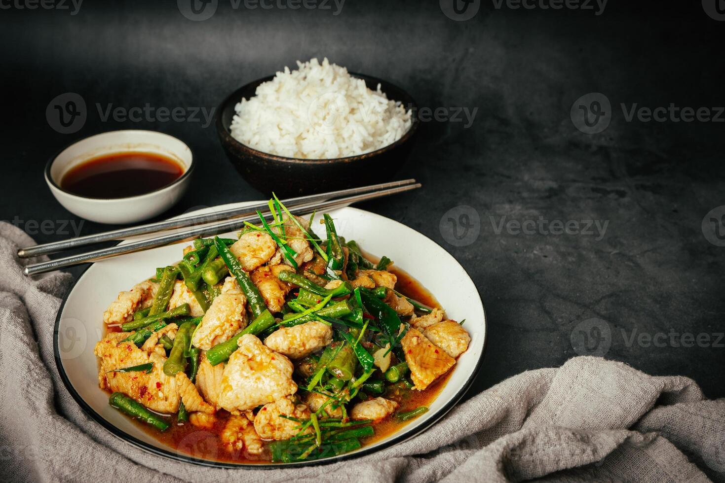 Close up, Stir-fried pork and red hot curry paste with or long bean and Ingredients are oyster sauce, fish sauce, sugar, kaffir lime leaves in the dish Eat with cooked rice. Thai food photo