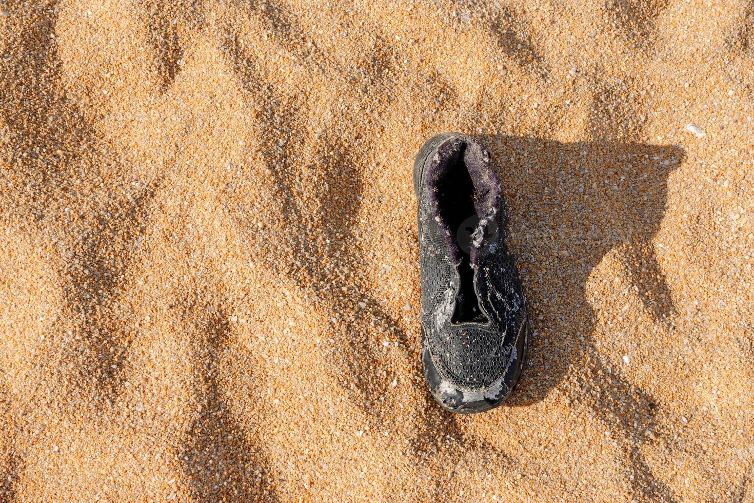 Garbage, shoes garbage the beach, sea water pollution with old shoes on sand in the beach, Environment and nature concept photo