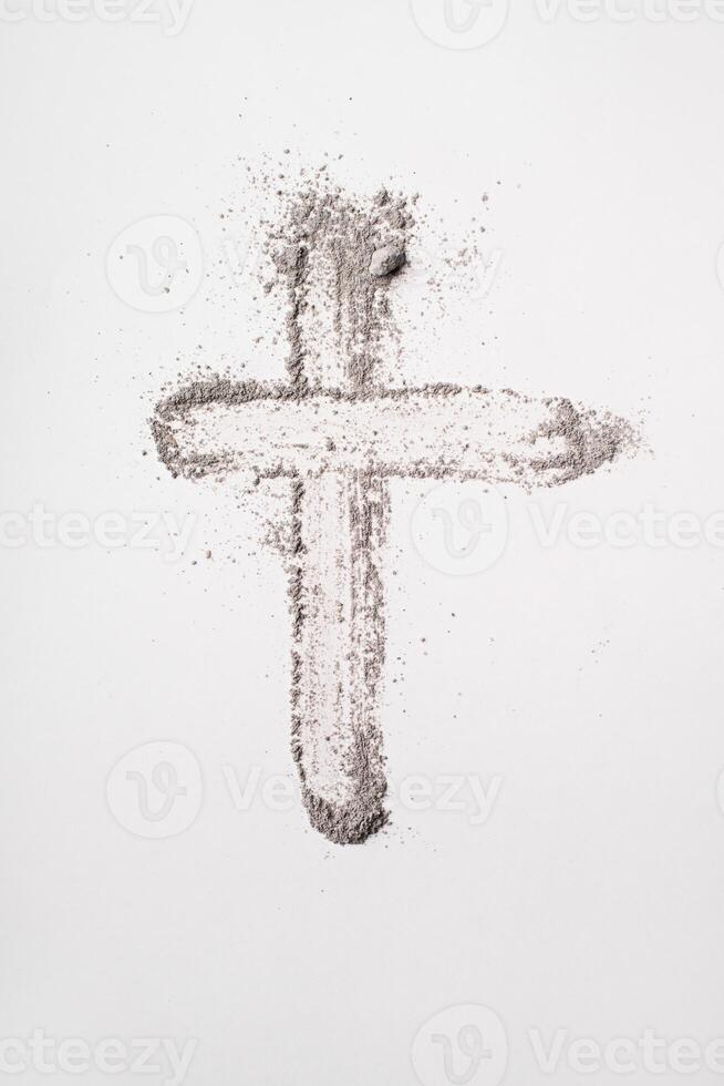 Ash cross symbol on white background for lent and religious reflection. Ash Wednesday photo