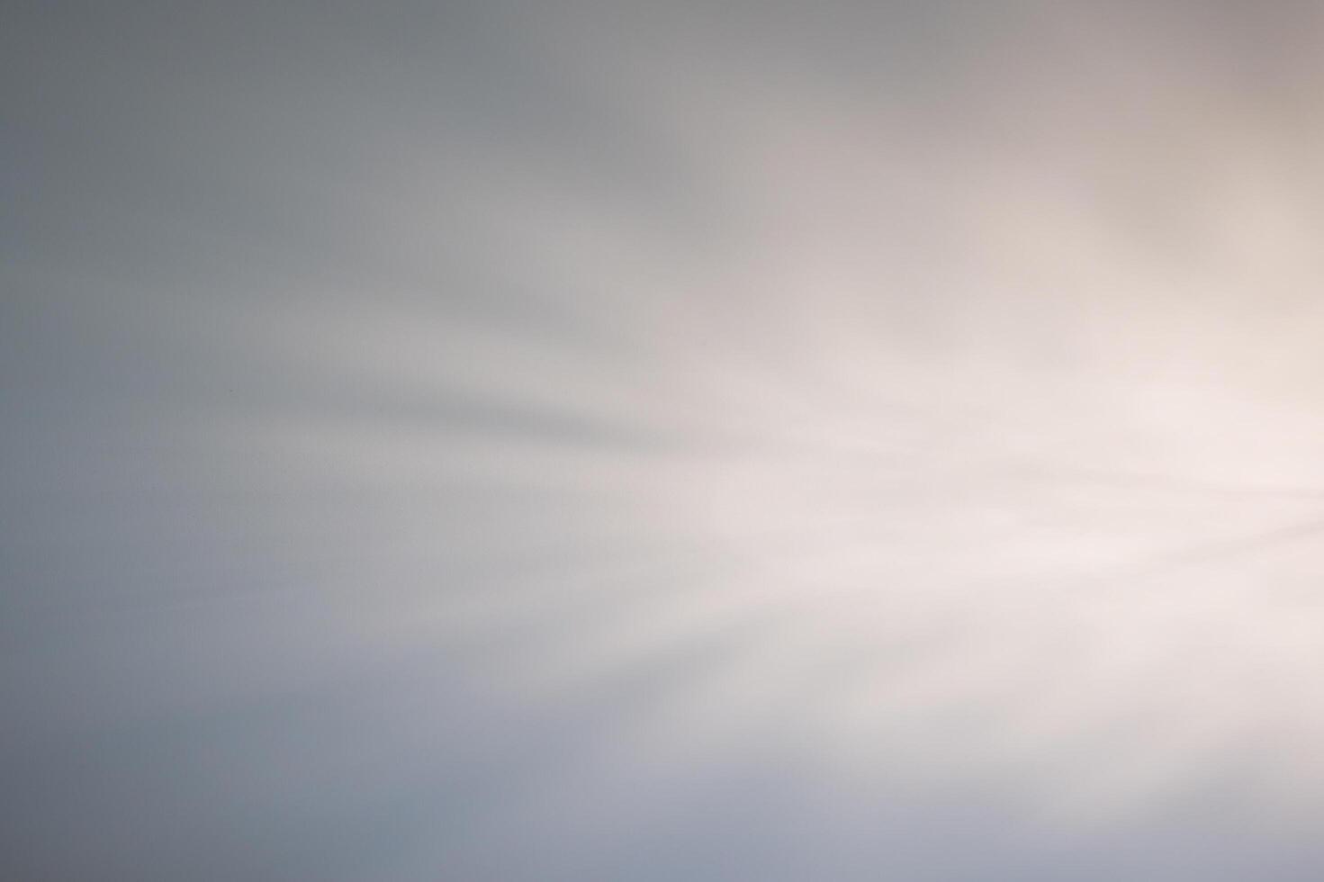 a white light is shining through a cloudy sky photo