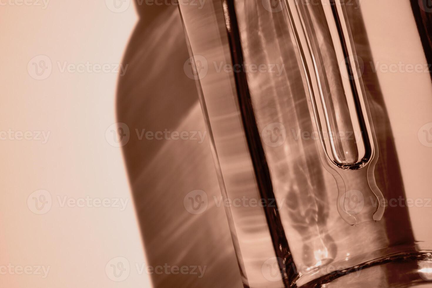 Dropper Bottle with cosmetic oil close-up in mocha mousse color photo