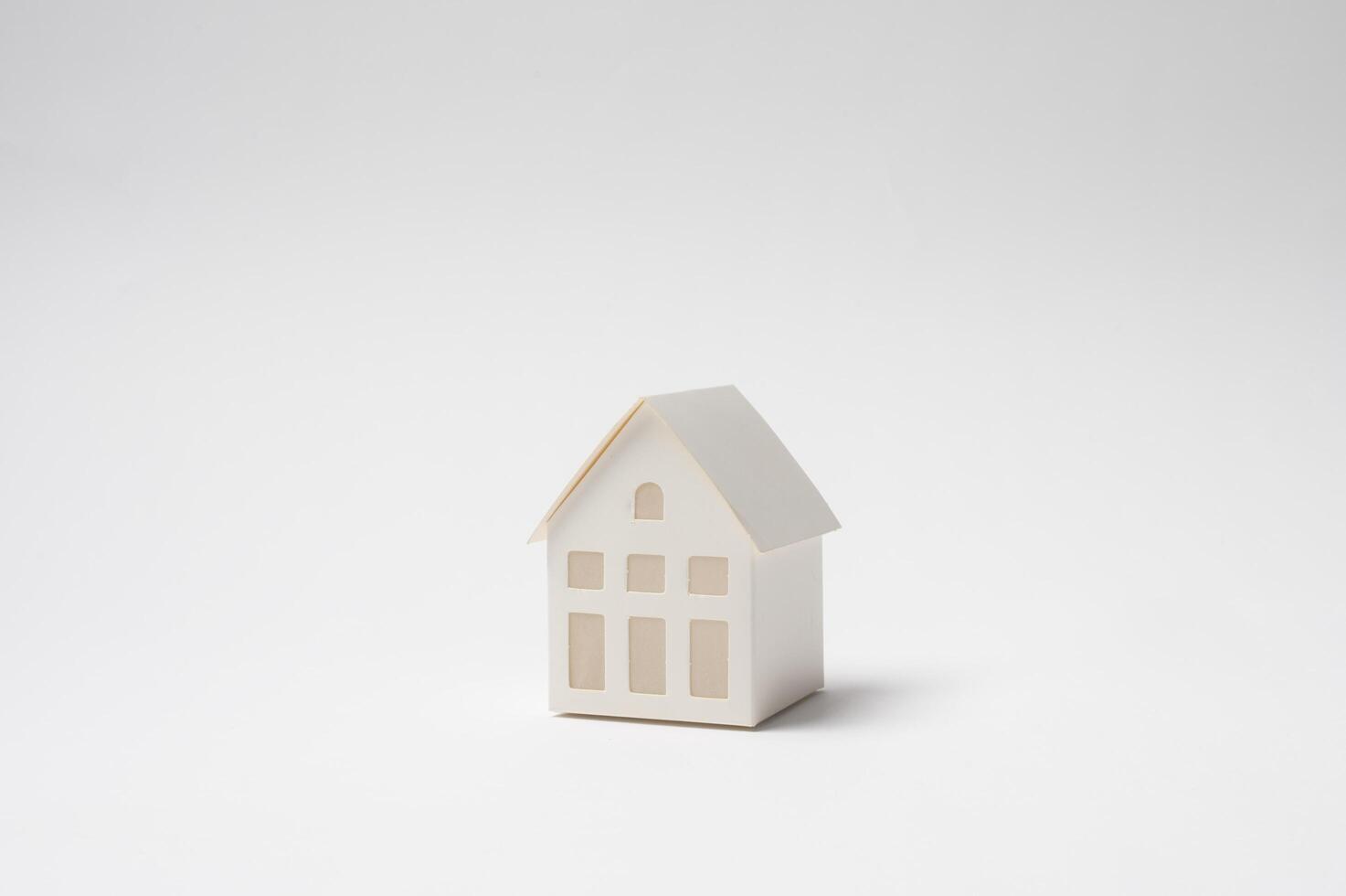 Small House Model on a Plain Background . photo