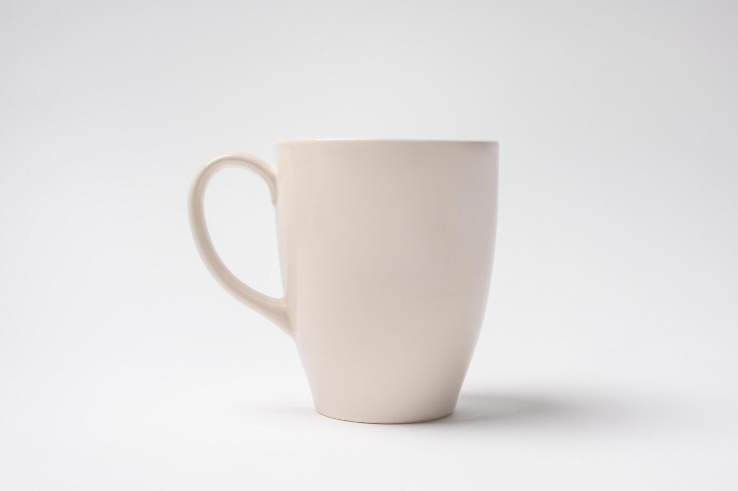 Simple White Mug Stands Upright on a Plain Background Highlighting Its Minimalist Design photo