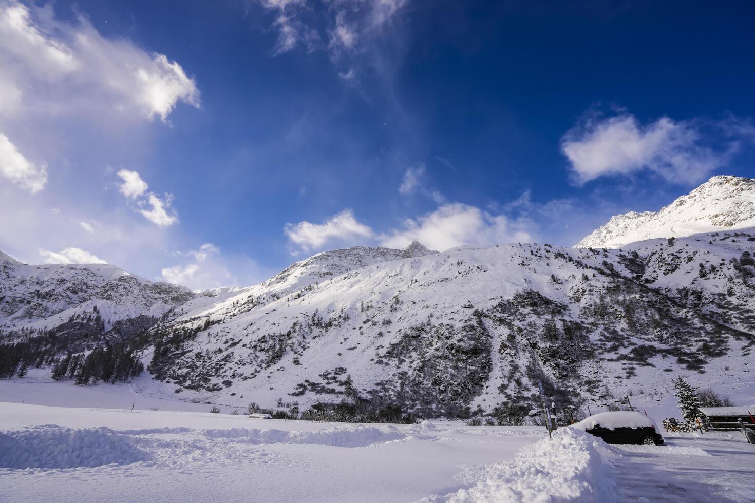 Partly cloudy weather in the Winter scenery in the Swiss Alps, Grisons, Switzerland photo