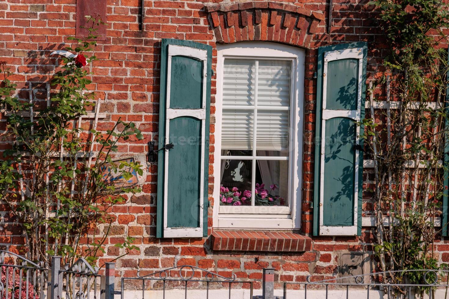 A brick building with green shutters photo