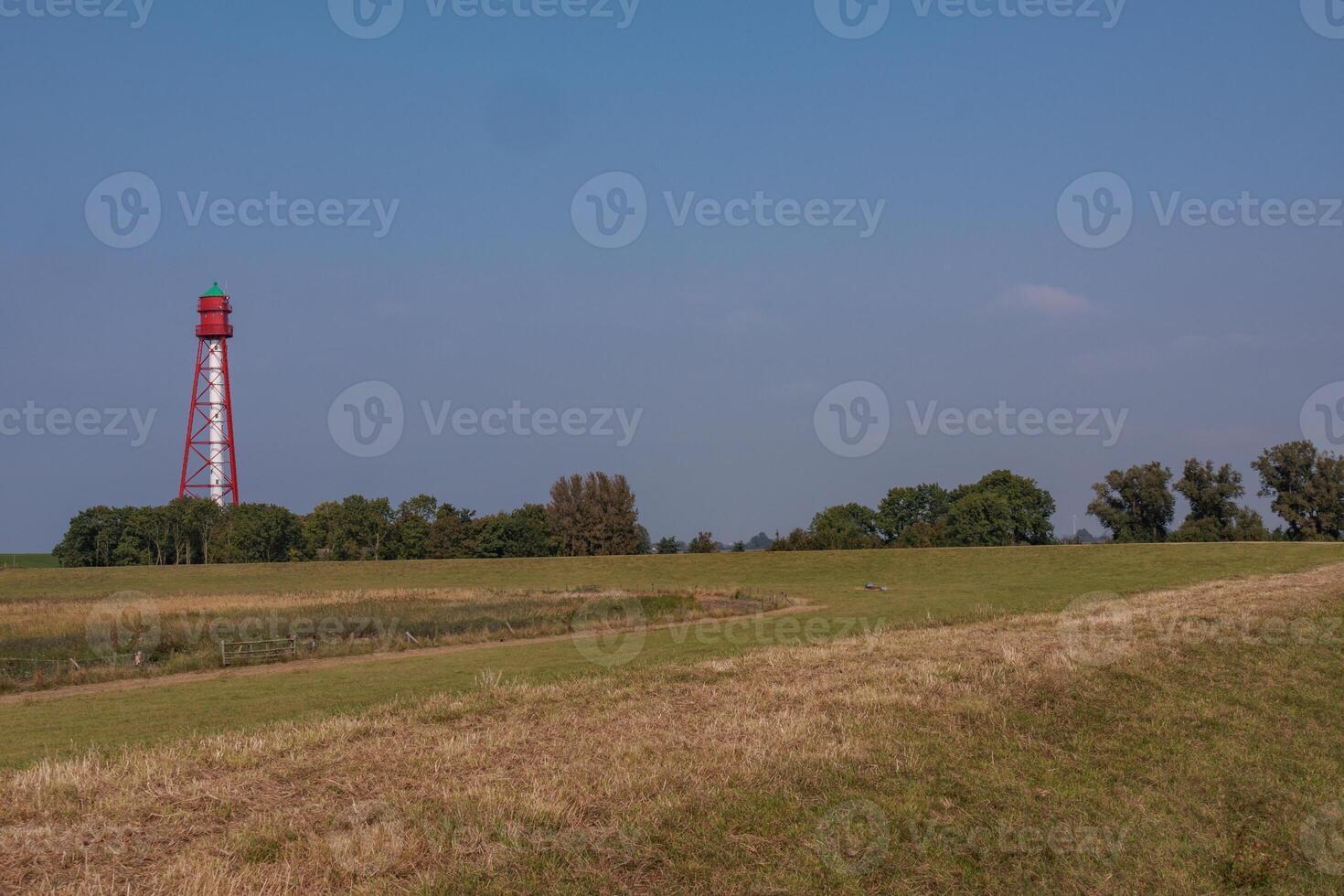 A field with a red light house photo