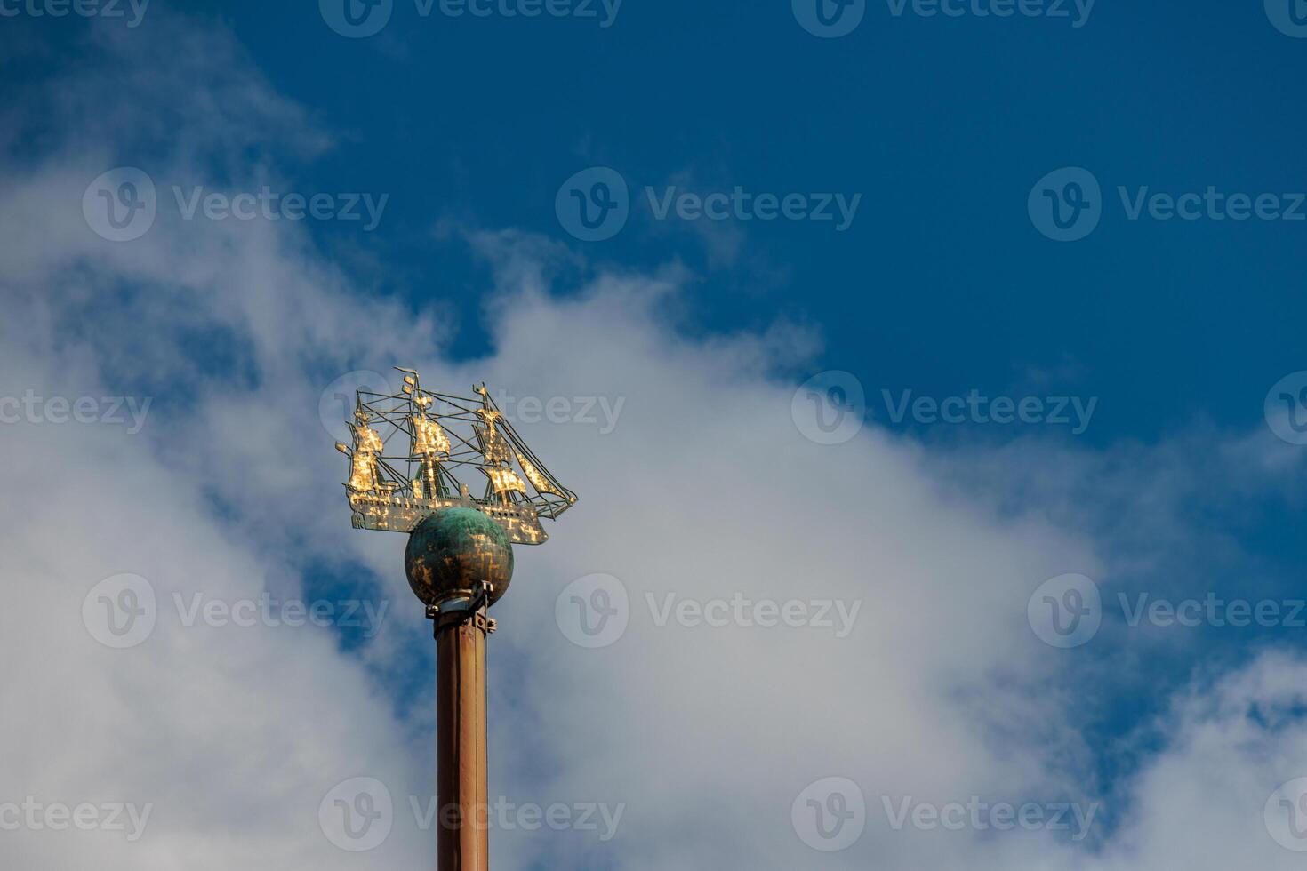 A tall metal pole with a sail on it photo