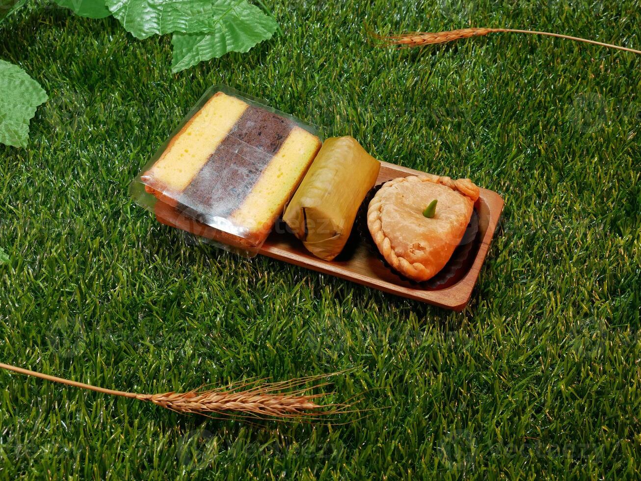 Traditional Indonesian snacks, various types of sweet and delicious snacks such as layer cakes, lemper, and pastel or patty photo