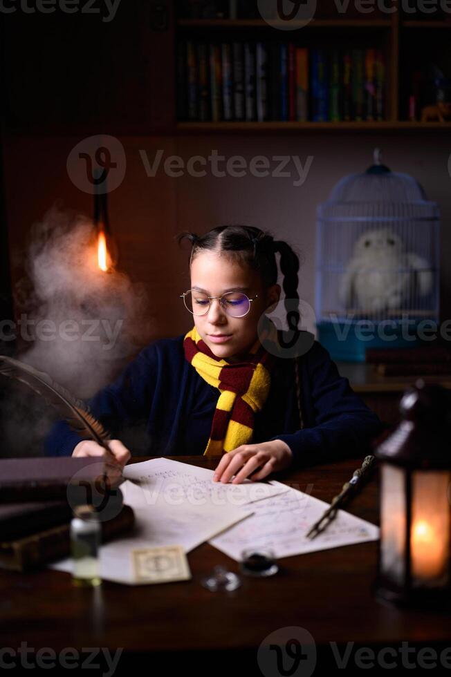 A girl's Harry Potter cosplay. Writing a letter with candles and an owl photo