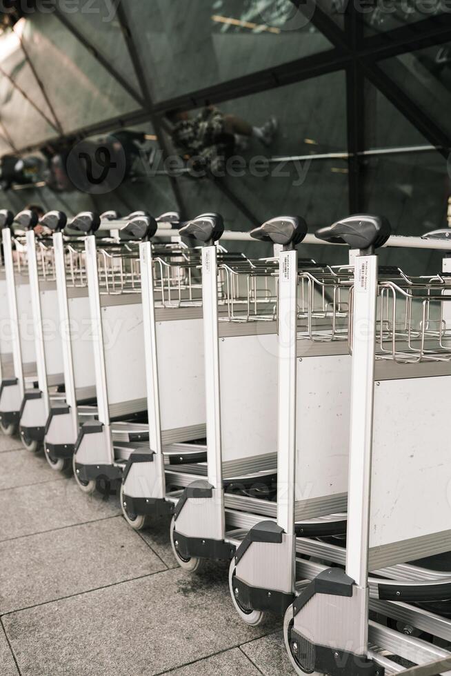 A row of luggage carts photo