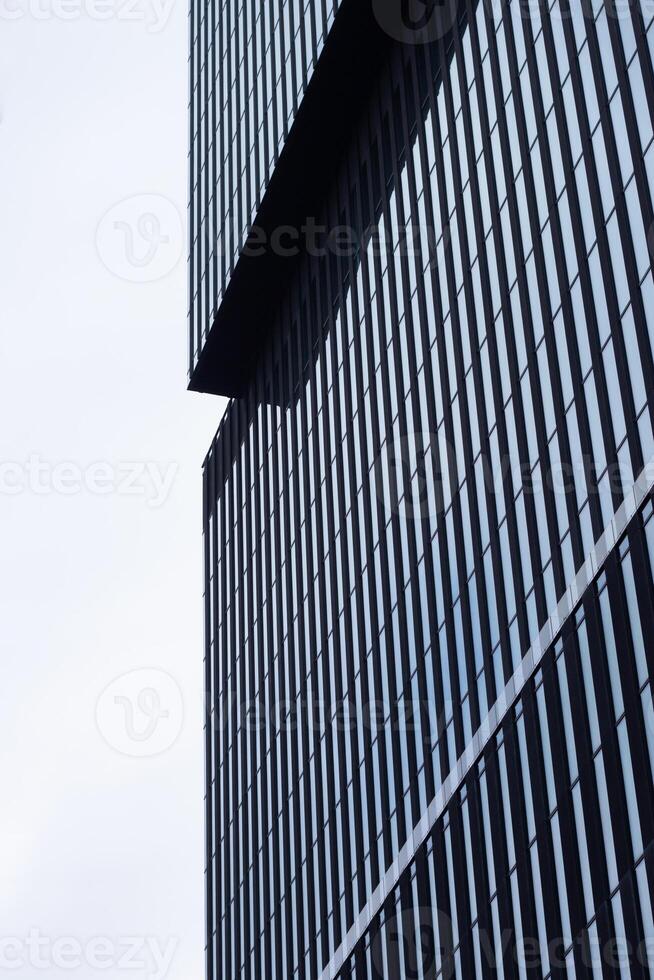 A black building with a clock on it photo